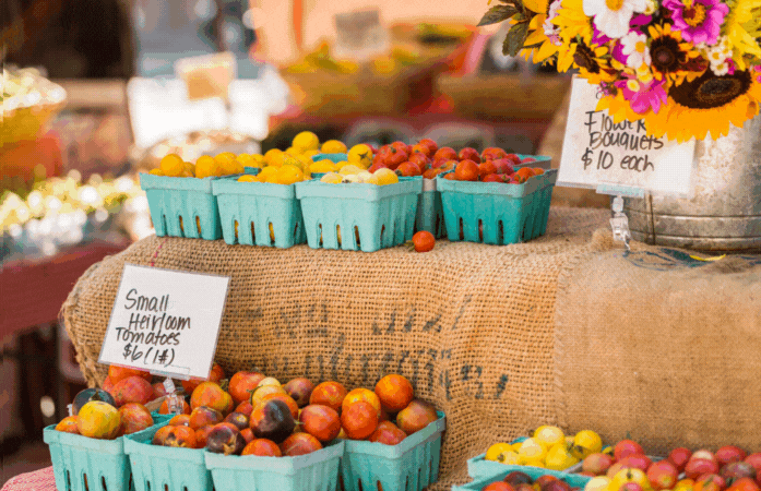 small baskets of fruit on a fruit stand